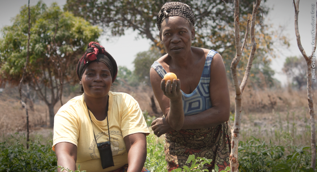 Two women in Zambia display the products of climate-smart agriculture