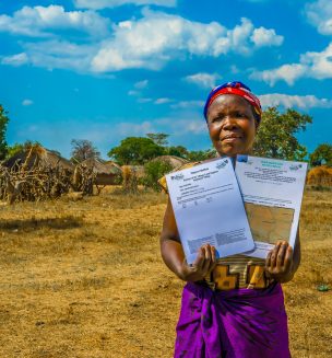Zambian woman holds land titles.