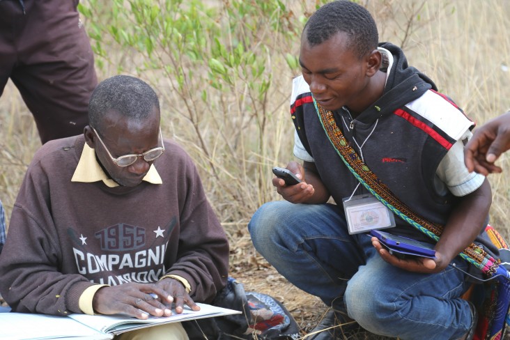 Gaspar Bangi, right, cross-checks data with an adjudicator from the Kiponzelo field surveying team