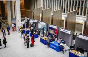 Image looking down on World Bank land conference booths from a upper level balcony.