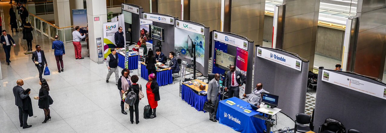 Image looking down on World Bank land conference booths from a upper level balcony.